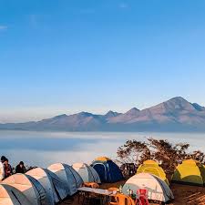Hilltop camping with mountain backdrop